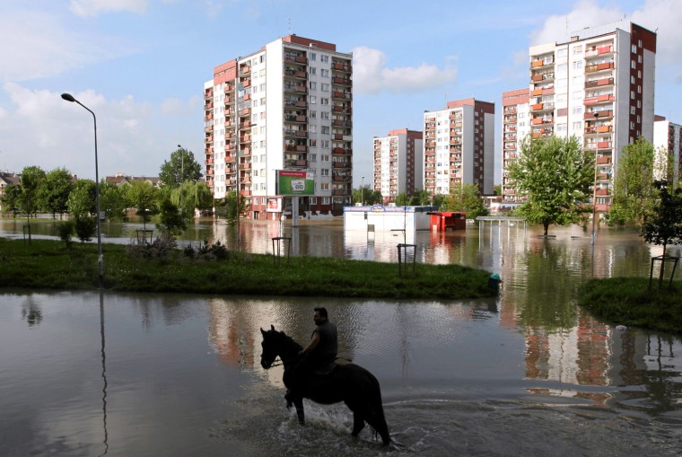 Image: A man rides a horse through a flooded area near the Sleza river Kozanow at the district of Wroclaw