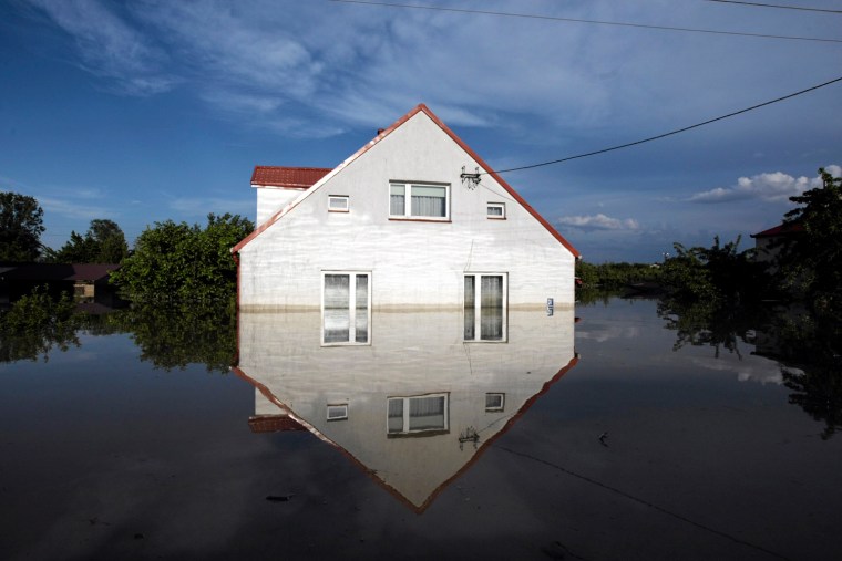 Image: A flooded house is pictured by the Vistula River in Sandomierz,