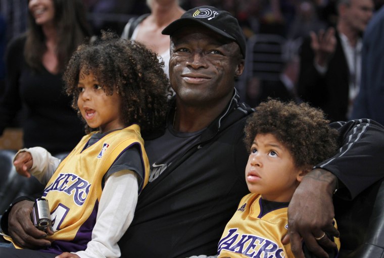 Image: Singer Seal sits with his two sons Henry and Johan as they watch the Los Angeles Lakers play the Oklahoma Thunder in Los Angeles