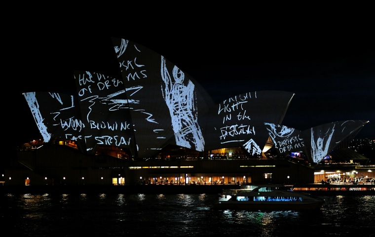 Image: A ferry idles past as the Sydney Opera H