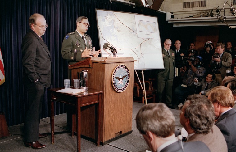 Image: US Defense Secretary Dick Cheney (R) stands by as
