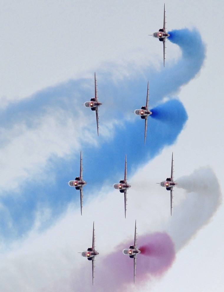 Image: The RAF Red Arrows perform during an air display at the Farnborough Airshow in southern England