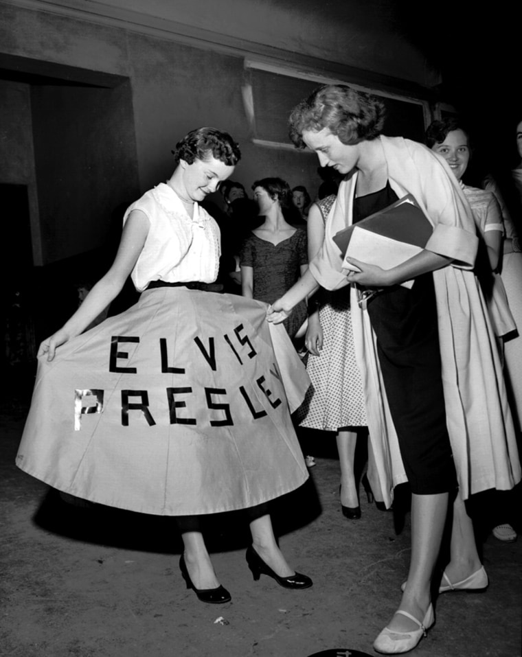 A fan shows off her dress at Elvis Presley's concert at Ellis Auditorium in 1956. More than 7,000 people jammed Ellis Auditorium on the night of May 15 to stomp, shudder, shriek and sigh as a young Elvis Presley writhed his way through a rock and roll repertoire. Presley was the blockbuster of Bob Neal's Cotton Picking Jamboree, a feature of Cotton Carnival opening night. (By Robert Williams / The Commercial Appeal)