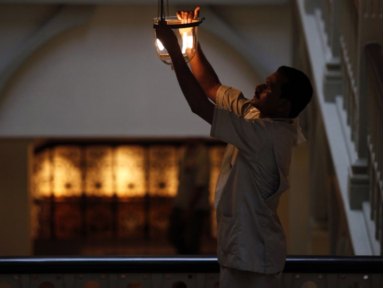 Image: An employee of the Taj Palace Hotel works inside the heritage wing of the hotel in Mumbai