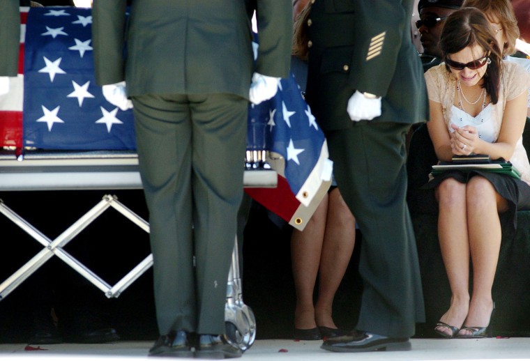 Cyndi Quinton, far right, wife of U.S. Army Spc. Bryan Quinton, 24, cries during her husband's graveside service at Green Hill Cemetery in Sapulpa, Okla., Wednesday, May 17, 2006. Quinton and another soldier were killed May 4 in Iraq when a roadside bomb went off near their military vehicle in Baghdad. He served with the 5th Engineer Battalion, 1st Engineer Brigade, out of Fort Leonard Wood, Mo. (AP Photo/Brandi Simons)