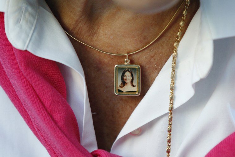 Image: Adams wears a necklace with a portrait of her daughter, Mary Lou Hague, who was 26 when she died in the attacks on the World Trade Center as family and friends of victims gather to mark the anniversary of the September 11, 2001 attacks on the World