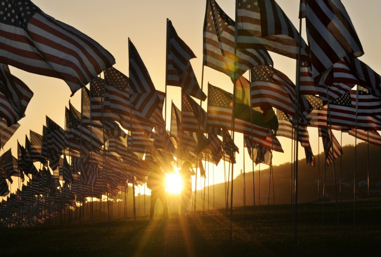Image: Americans walk amongst flags erected by