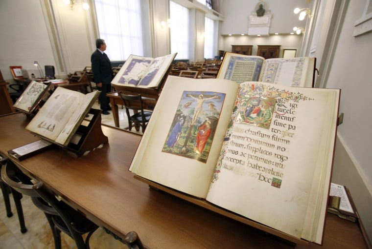 Image: Manuscripts are seen in the renovated Vatican Apostolic Library during its unveiling at the Vatican