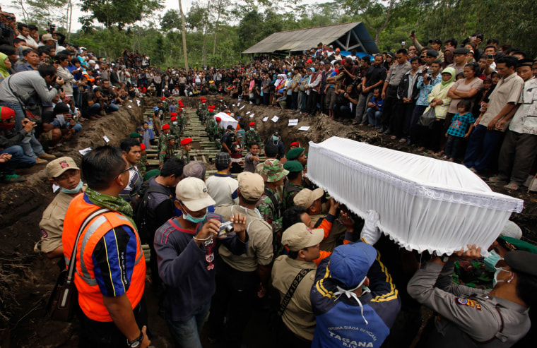 Image: Indonesian policemen and volunteers carry the coffin of a victim of the Mount Merapi eruption during a mass burial at Umbulhardjo village in Sleman, near the ancient city of Yogyakarta
