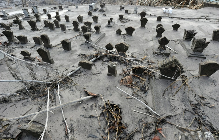 Image: A cemetary is pictured covered with ash