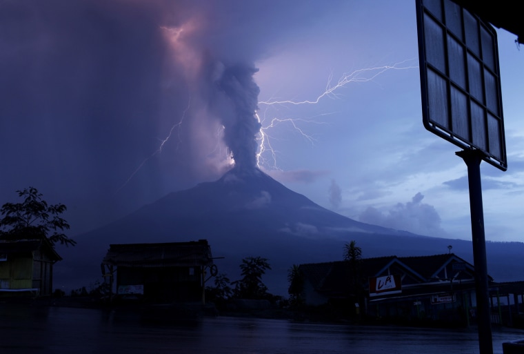 Image: Lightning strikes as Mount Merapi volcano erupts spewing out towering clouds of hot gas and debris, as seen from Ketep village in Magelang