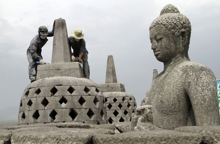 Image: Workers clear volcanic ash from the eruption of Mount Merapi volcano covering the Borobudur Temple in Muntilan of Indonesia's central Java province