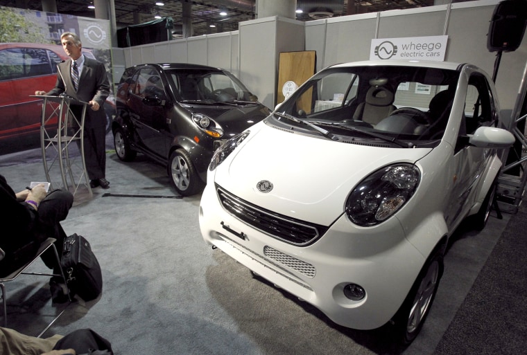 Image: McQuary, CEO of Wheego, speaks beside two Wheego Whip Life at the LA Auto Show in Los Angeles