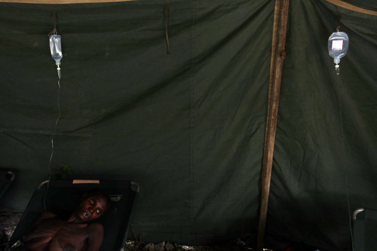 Image: A woman suffering from cholera rests at