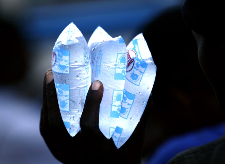 Image: A resident holds packets of water to sell in downtown Port-au-Prince