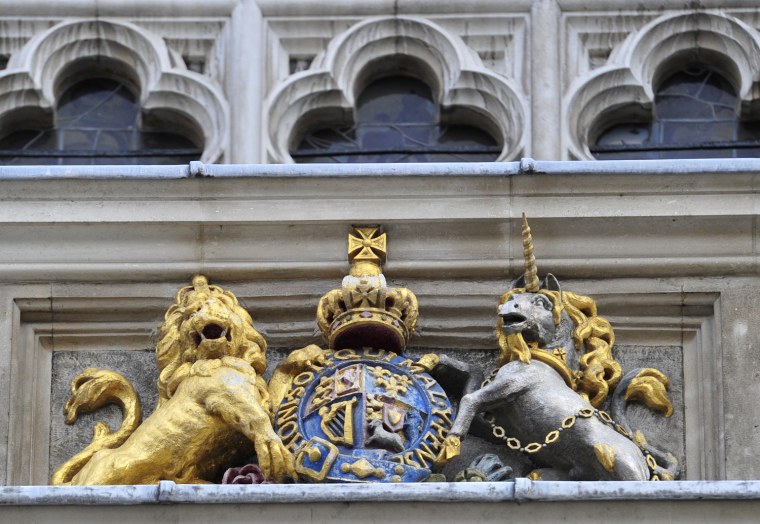 Image: The Royal insignia is seen above the Great West Door entrance of Westminster Abbey in central London