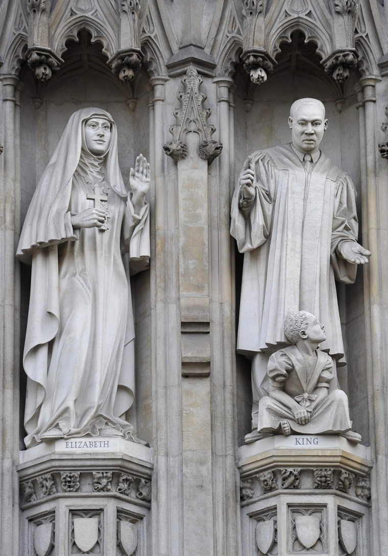 Image: Statues are seen above the Great West Door entrance of Westminster Abbey in central London