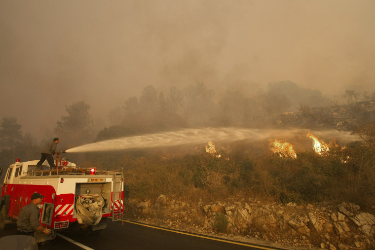 Image: Israeli firefighters work at the fire site