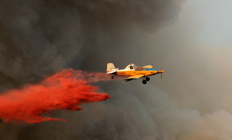 Image: An Israeli firefighter plane helps to ex