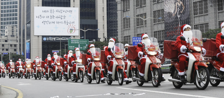 Image: Postmen dressed as Santa Claus ride on their delivery motorbikes during an event to begin their Christmas season service at the Central Post Office in Seoul