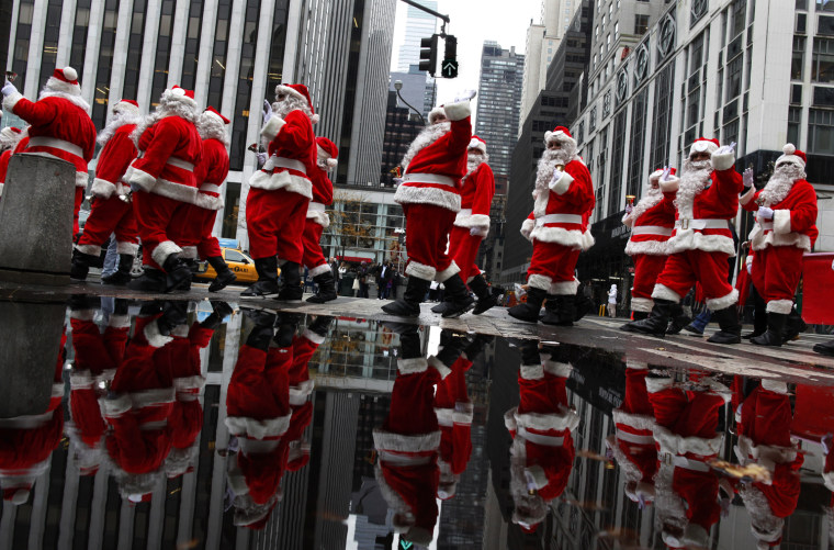 Image: Volunteers of America's Sidewalk Santas kick off the holiday season walking through Midtown Manhattan during the 108th Annual Parade of Santas in New York