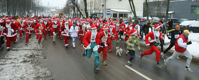 Image: People dressed as Santa Claus take part