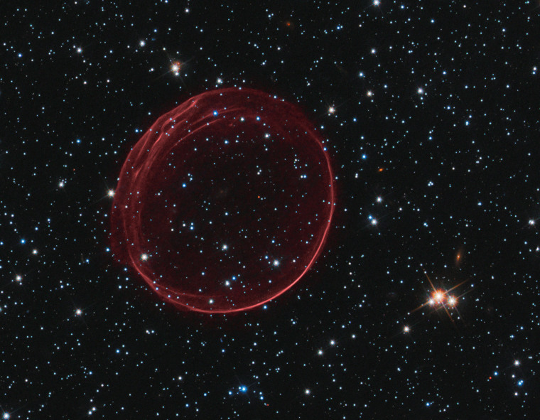December 14, 2010: A delicate sphere of gas, photographed by NASA's Hubble Space Telescope, floats serenely in the depths of space. The pristine shell, or bubble, is the result of gas that is being shocked by the expanding blast wave from a supernova. Called SNR 0509-67.5 (or SNR 0509 for short), the bubble is the visible remnant of a powerful stellar explosion in the Large Magellanic Cloud (LMC), a small galaxy about 160,000 light-years from Earth. Ripples in the shell's surface may be caused by either subtle variations in the density of the ambient interstellar gas, or possibly driven from the interior by pieces of the ejecta. The bubble-shaped shroud of gas is 23 light-years across and is expanding at more than 11 million miles per hour (5,000 kilometers per second). NASA, ESA, and the Hubble Heritage Team (STScI/AURA)