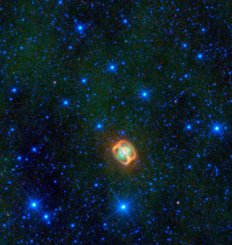 A colorful creature in a starry sea stands out in this image from NASA's Wide-field Infrared Explorer, or WISE. The image shows infrared light that has been assigned visible colors we see with our eyes. The jellyfish-looking object is actually a very close pair of dying stars (white) surrounded by their shed material (green), and two very unusual dust rings (orange) discovered by WISE. 

The object, named NGC 1514, is what is termed a planetary nebula. These are dying stars similar to our sun, that blow off their outer layers, sometimes forming beautiful, perfectly round orbs, and sometimes colorful butterfly shapes. In the case of NGC 1514, astronomers think there are two central stars orbiting each other; WISE cannot distinguish between the two stars, so only one white dot is seen. One star is an aging giant a bit warmer than our sun; the other was an even larger star that has already transformed into an ultra-hot white dwarf. The unusual rings, which are not quite like anything ever seen before aro