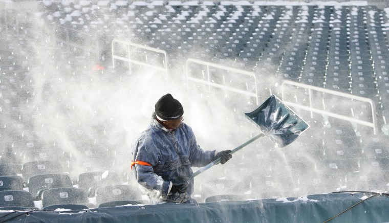 Image: A worker clears snow from the seats at the Philadelphia Eagles stadium in Philadelphia Pennsylvania