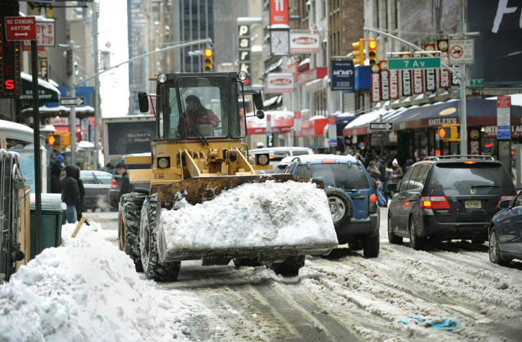 Image: A front-end loader is used to remove sno