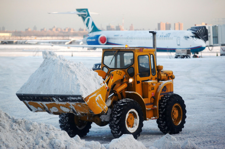 Трактор чистит снег фото Snow blankets the Northeast after hitting the South