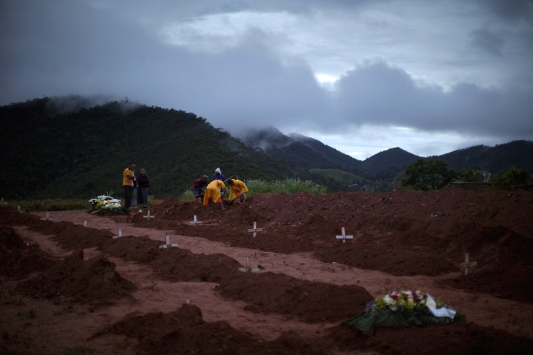 Image: People bury victims of a landslide in Teresopolis, Rio de Janeiro state, Brazil,