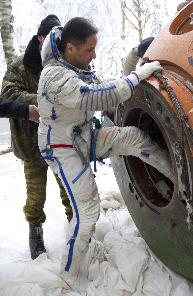 Image: NASA astronaut Joseph Acaba of the U.S. gets out of a landing capsule as he undergoes a survival training course in Star City