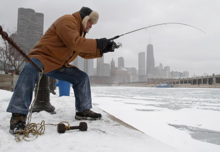 Image: A man fishes in Lake Michigan in Chicago