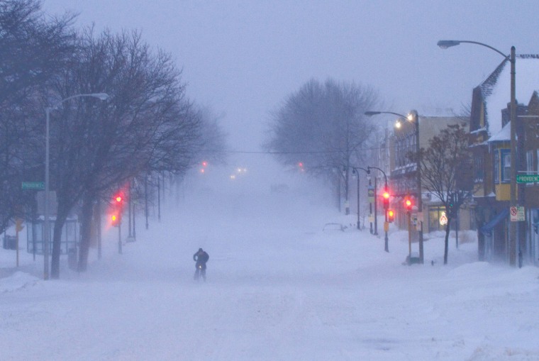 Image: A cyclist tries to ride during a blizzard in Milwaukee