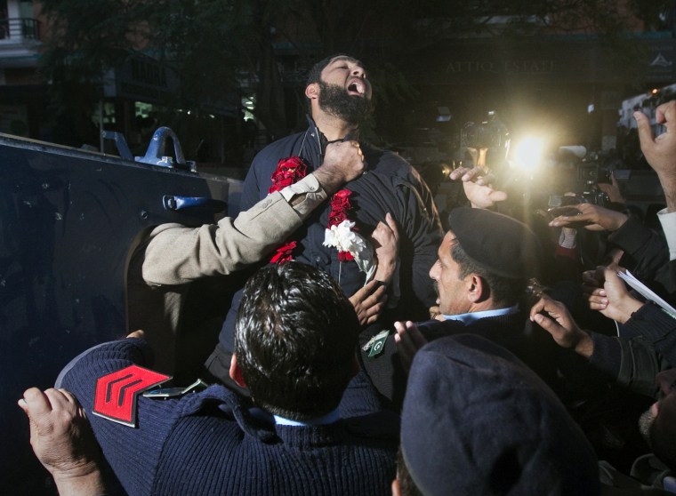 Image: Qadri, bodyguard arrested for the killing of Punjab Governor Taseer, shouts religious slogans while being taken away by police after he was presented at a court in Islamabad