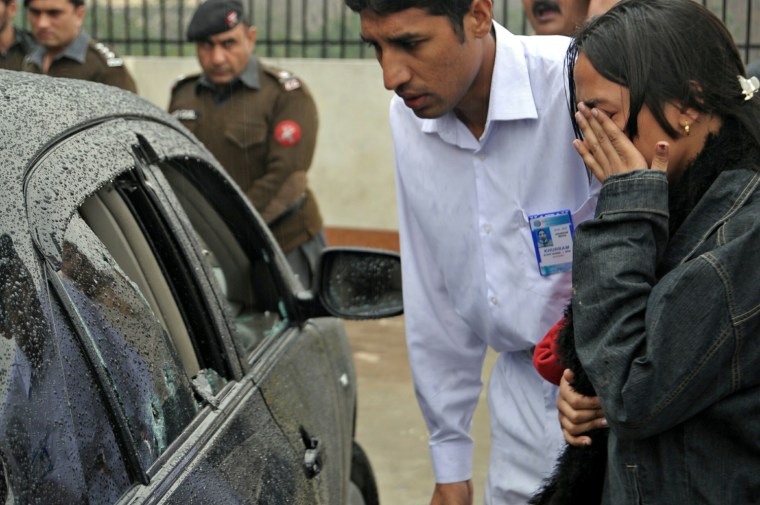 Image: Rlatives of slain Pakistan Minorities Minister Shahbaz Bhatti reacts as they inspect his bullet-riddled car