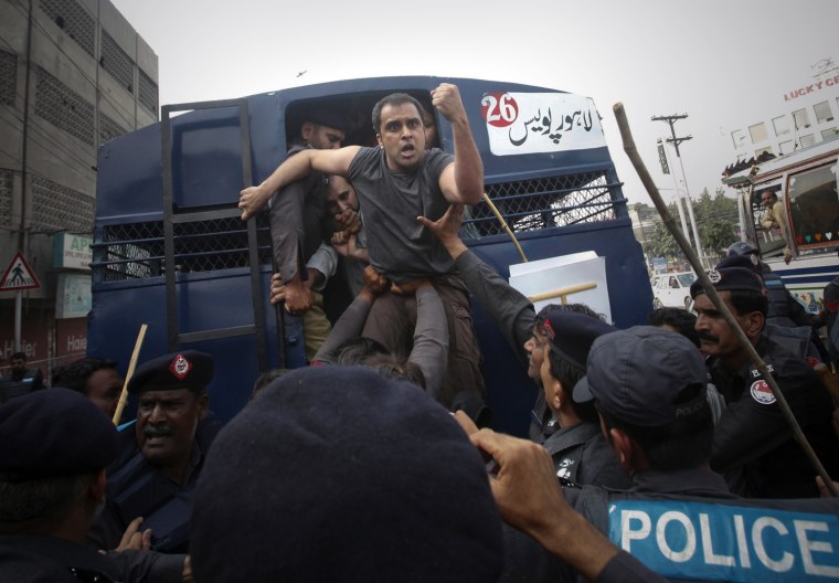 Image: Police detain an activist during an anti-American protest in Lahore Pakistan