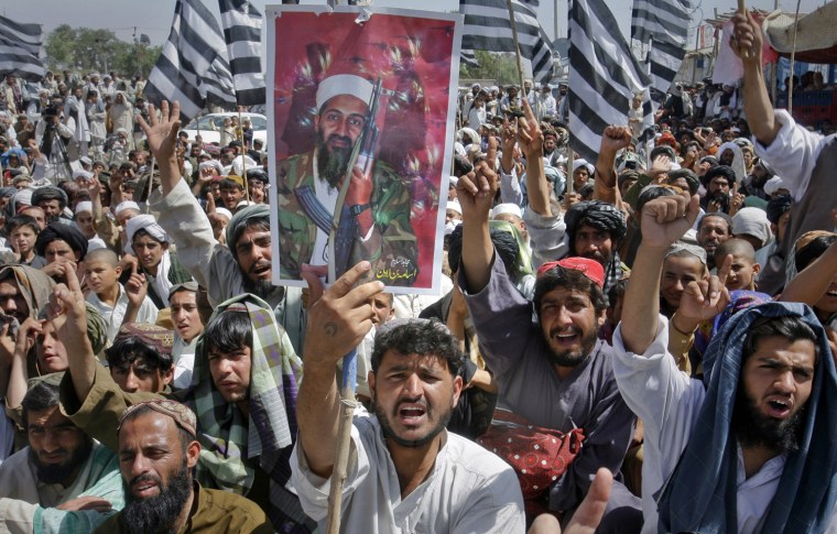 Image: Supporters of Pakistani religious party Jamiat-e-ulema-e-Islam hold an image of Osama bin Laden on the outskirts Quetta