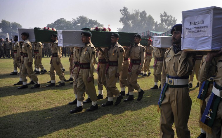 Image: Shaheed, or martyr, is written on the caskets of soldiers killed in a cross-border attack along the Pakistan-Afghan border, as their bodies are being carried for funeral prayers in Peshawar