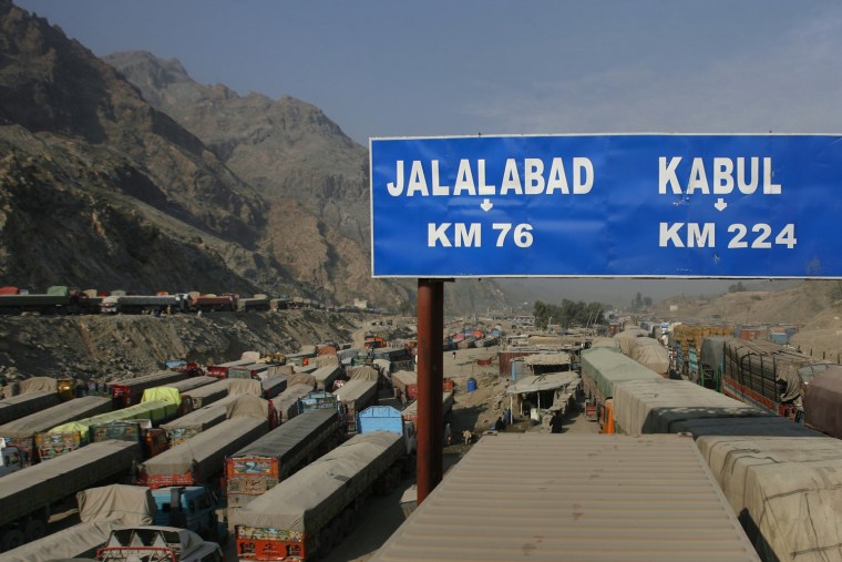 Image: A roadsign shows the distance to cities in Afghanistan after traffic was halted at the Pakistani border town Torkham