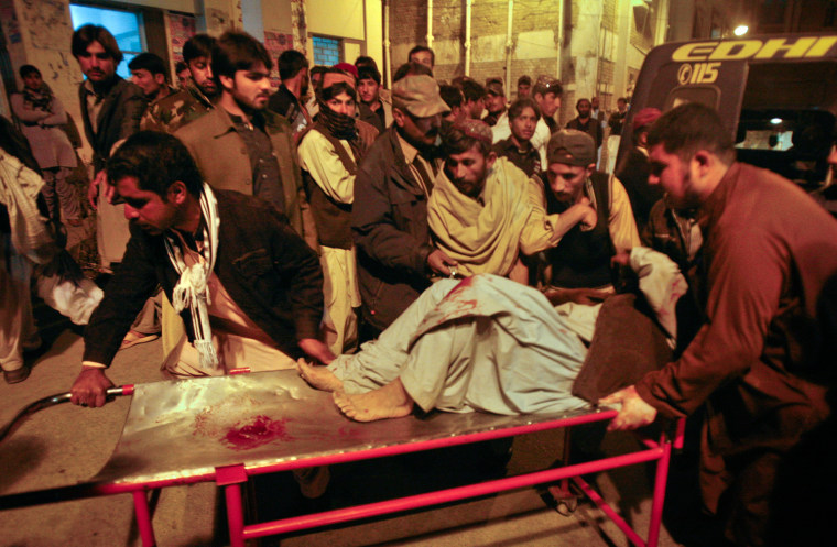 Image: A man, injured from the site of a bomb explosion, is brought to a hospital for treatment in Quetta