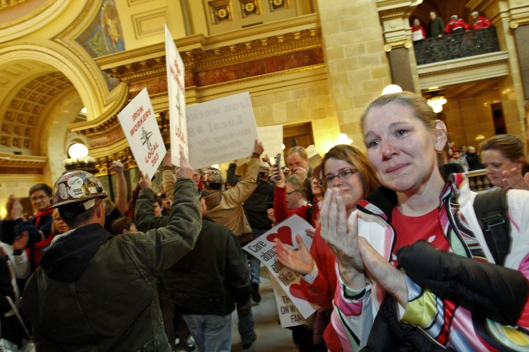 Image: Wisconsin teacher cries as iron workers show their support for the Teachers' Union