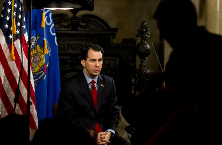 Image: Wisconsin Governor Scott Walker pauses for a moment in Madison
