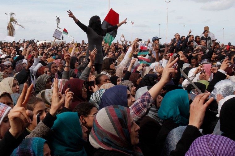Image: Protesters chant anti-government slogans in a square in Benghazi city