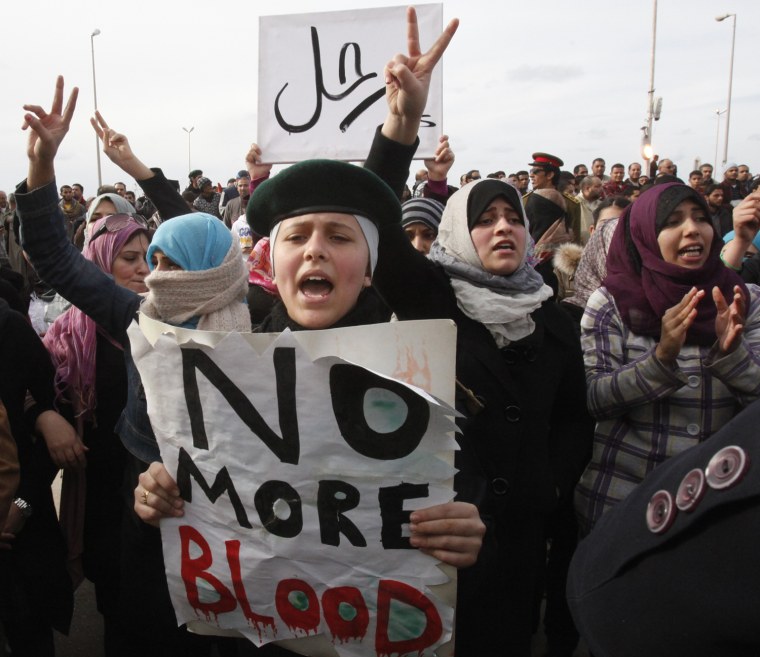 Image: Protesters chant anti-government slogans as they demonstrate in a square in Benghazi city