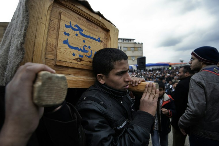 Image: Friends and relatives carry the coffin o