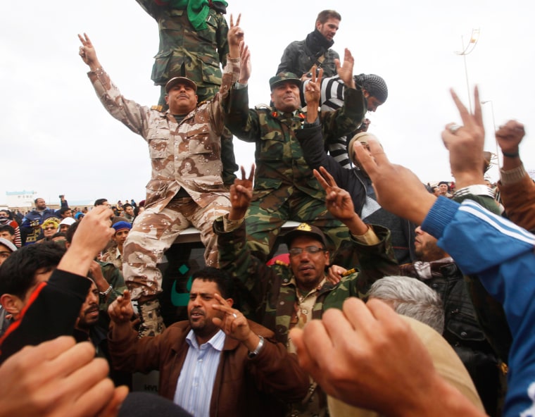 Image: Former military officers are welcomed by the anti-Gaddafi protesters in Benghazi