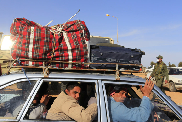 Image: Egyptians are transported by a Tunisian car at the Libyan and Tunisian border crossing of Ras Jdir