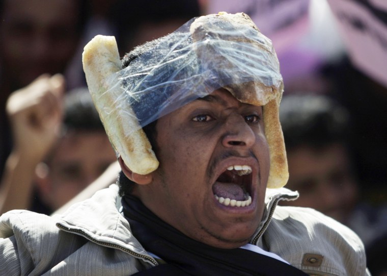Image: Opposition supporter with pieces of bread on his head shouts slogans during anti-government protest in Sanaa